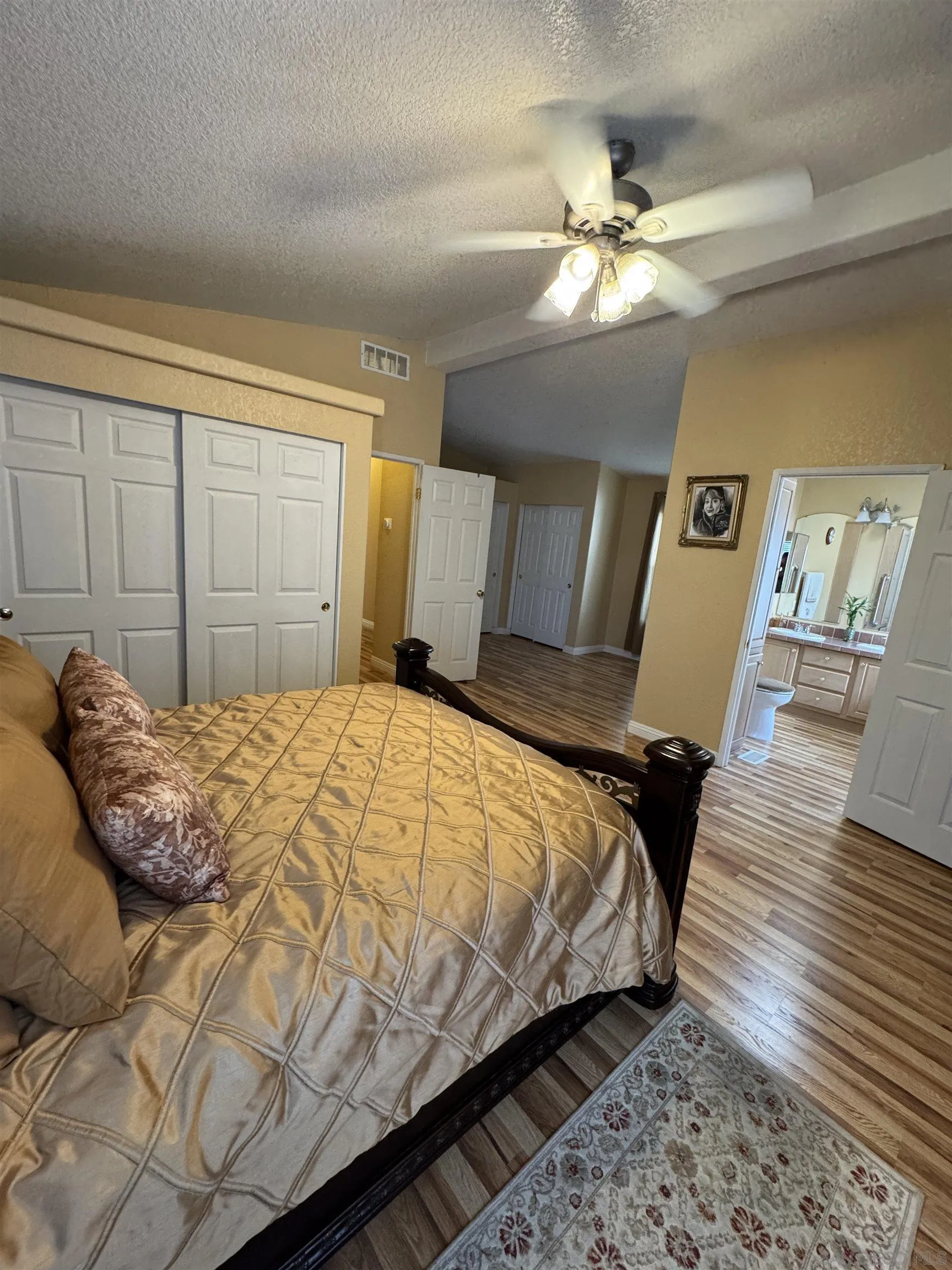 12250 Vista Del Cajon Road, Unit 25 El Cajon, CA 92021 - Photo 19 of 39 a bedroom with a large bed and a chandelier