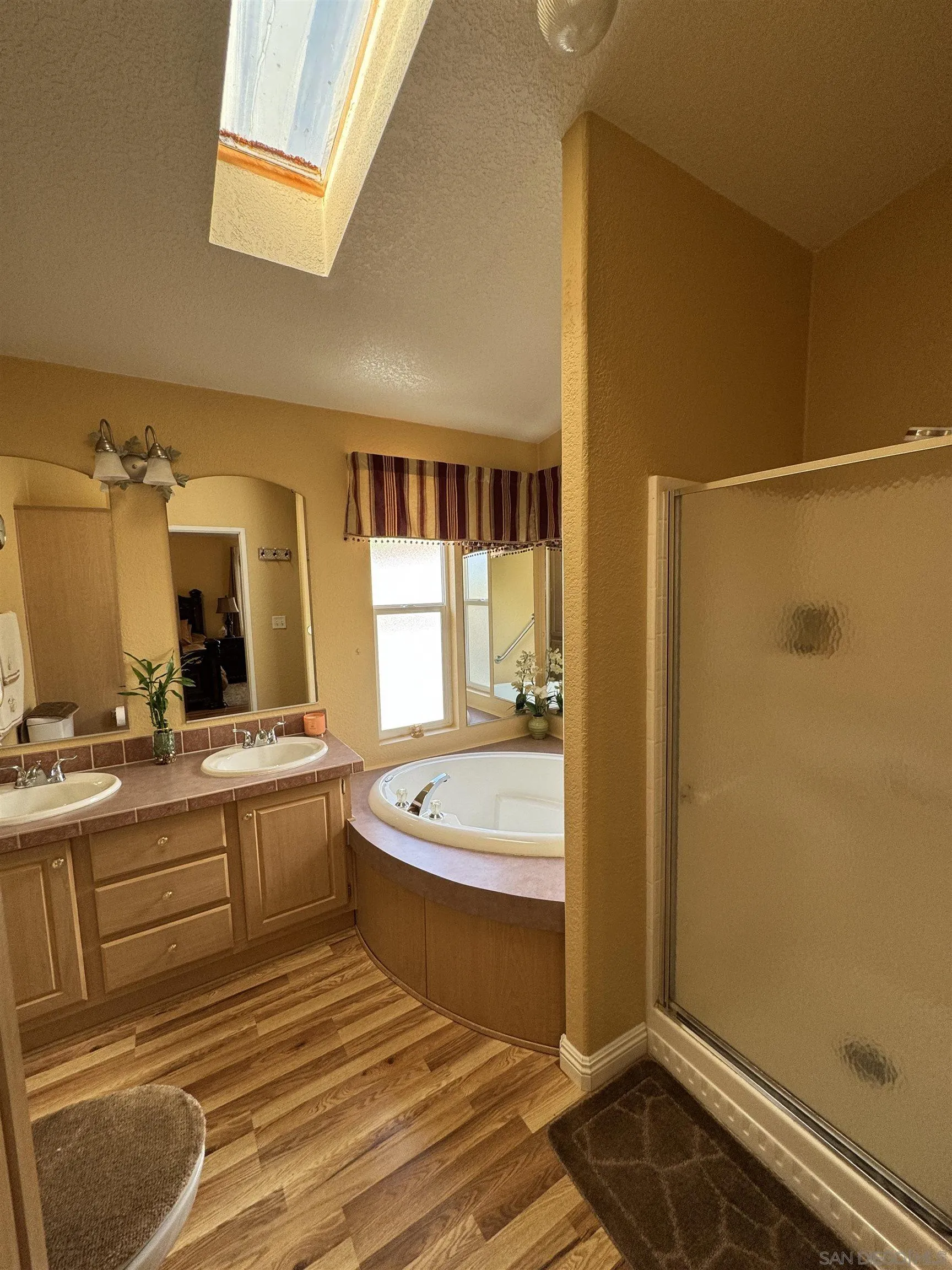 12250 Vista Del Cajon Road, Unit 25 El Cajon, CA 92021 - Photo 21 of 39 a spacious bathroom with a granite countertop sink and a mirror