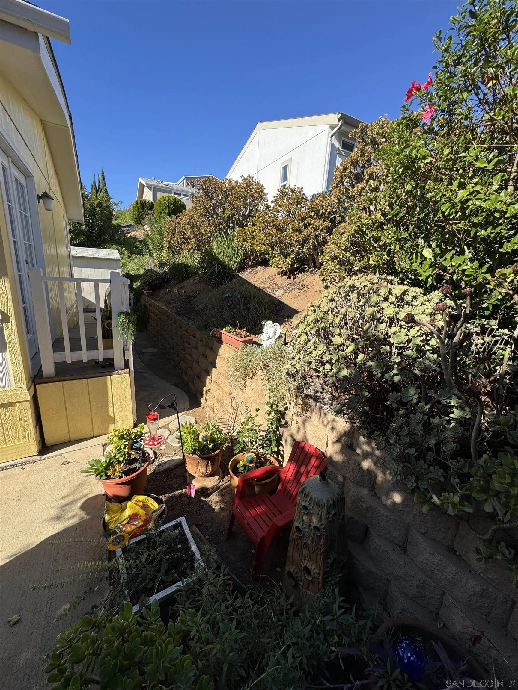 12250 Vista Del Cajon Road, Unit 25 El Cajon, CA 92021 - Photo 33 of 39 a backyard of a house with table and chairs potted plants