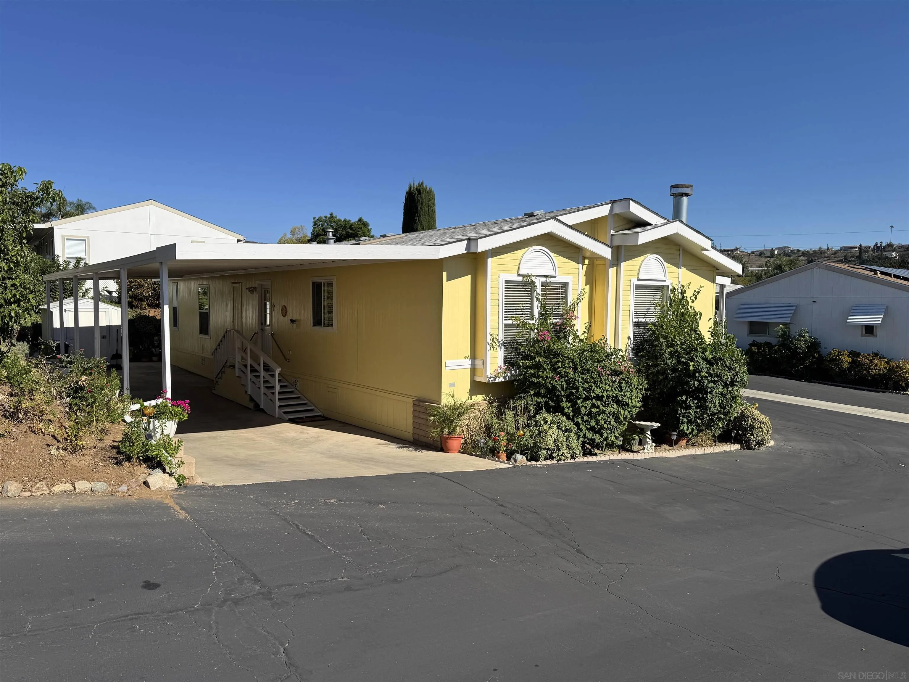 12250 Vista Del Cajon Road, Unit 25 El Cajon, CA 92021 - Photo 36 of 39 a front view of a house with a yard