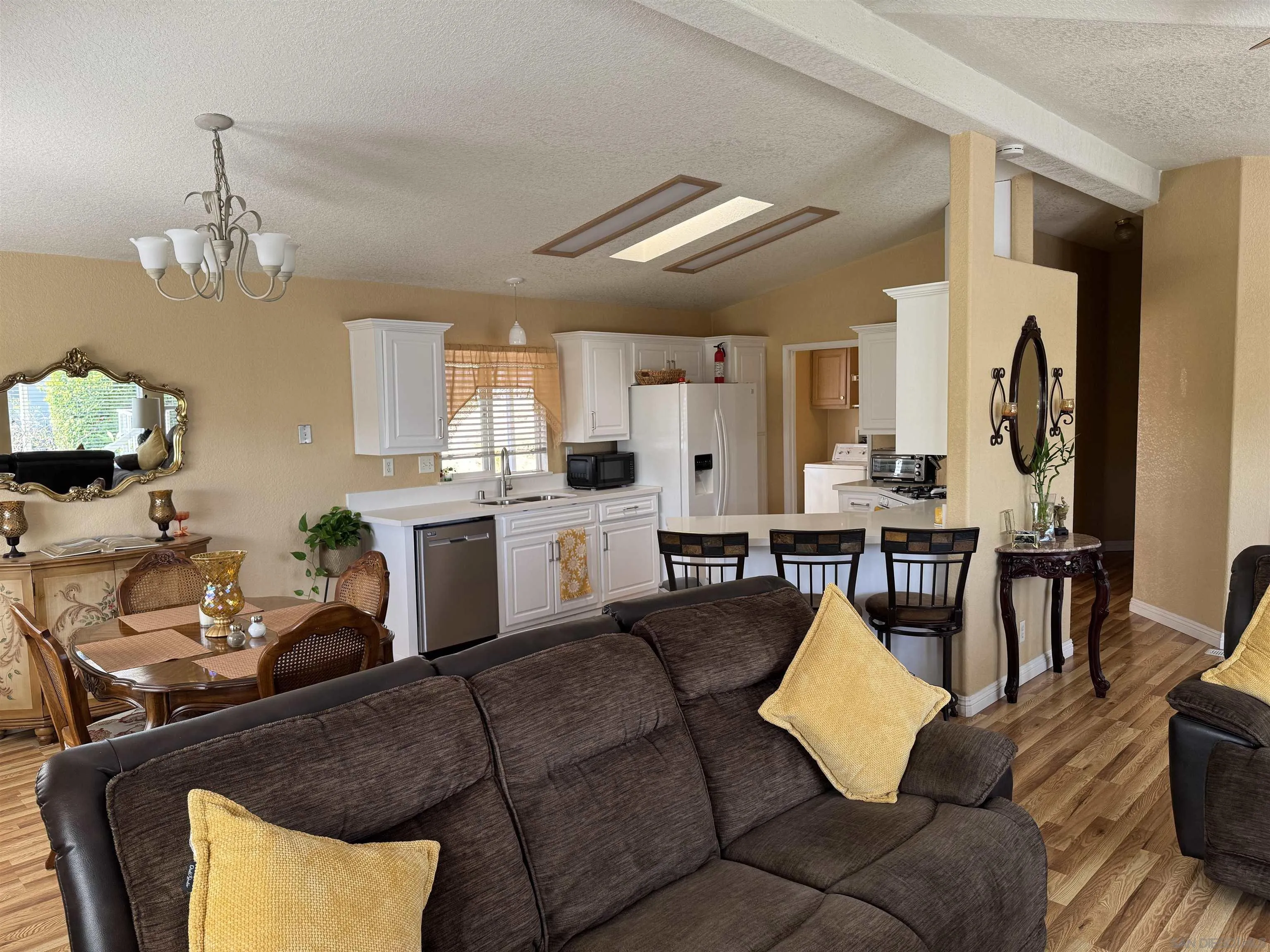 12250 Vista Del Cajon Road, Unit 25 El Cajon, CA 92021 - Photo 6 of 39 a living room with furniture kitchen view and a chandelier