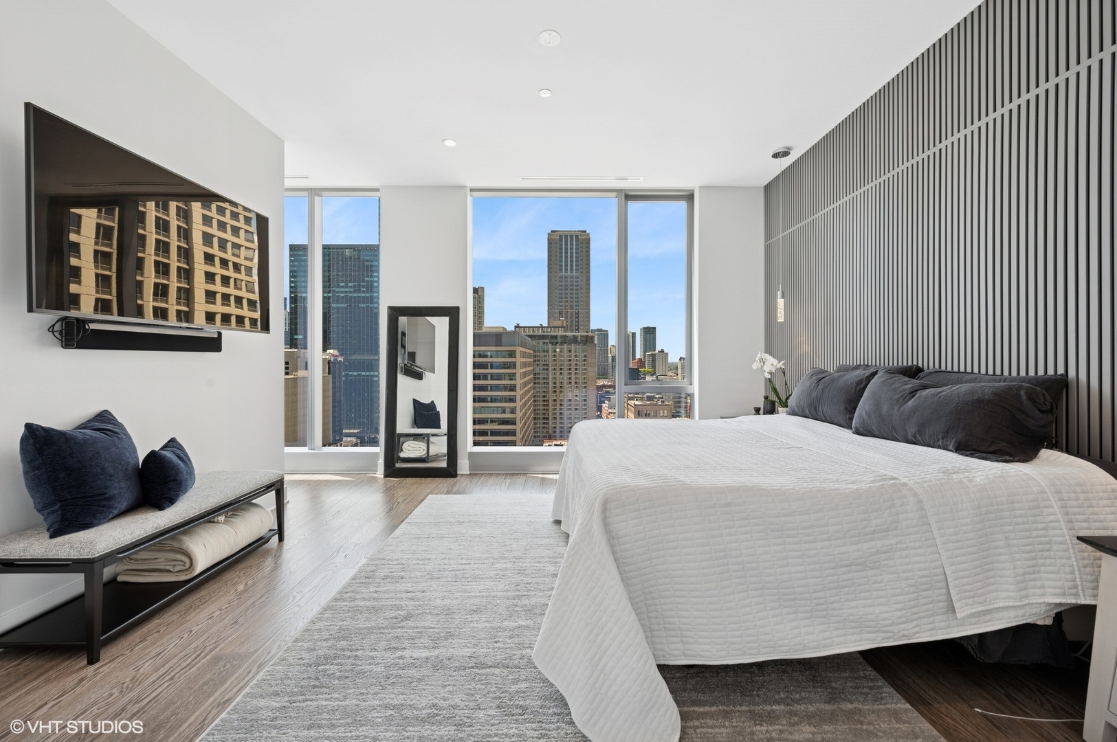 403 North Wabash Avenue, Unit 17C Chicago, IL 60611 - Photo 11 of 30 a bedroom with a bed and wooden floor