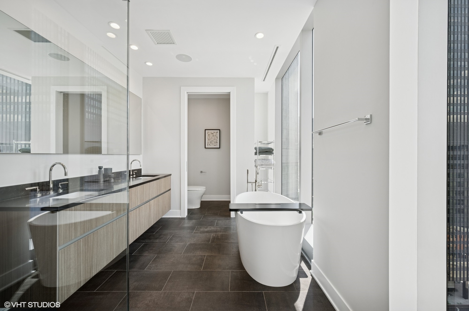 403 North Wabash Avenue, Unit 17C Chicago, IL 60611 - Photo 15 of 30 a large bathroom with a granite countertop sink a toilet and a mirror