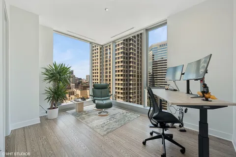 a view of a workspace with furniture and a potted plant