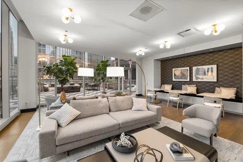 a living room with furniture kitchen view and a large window