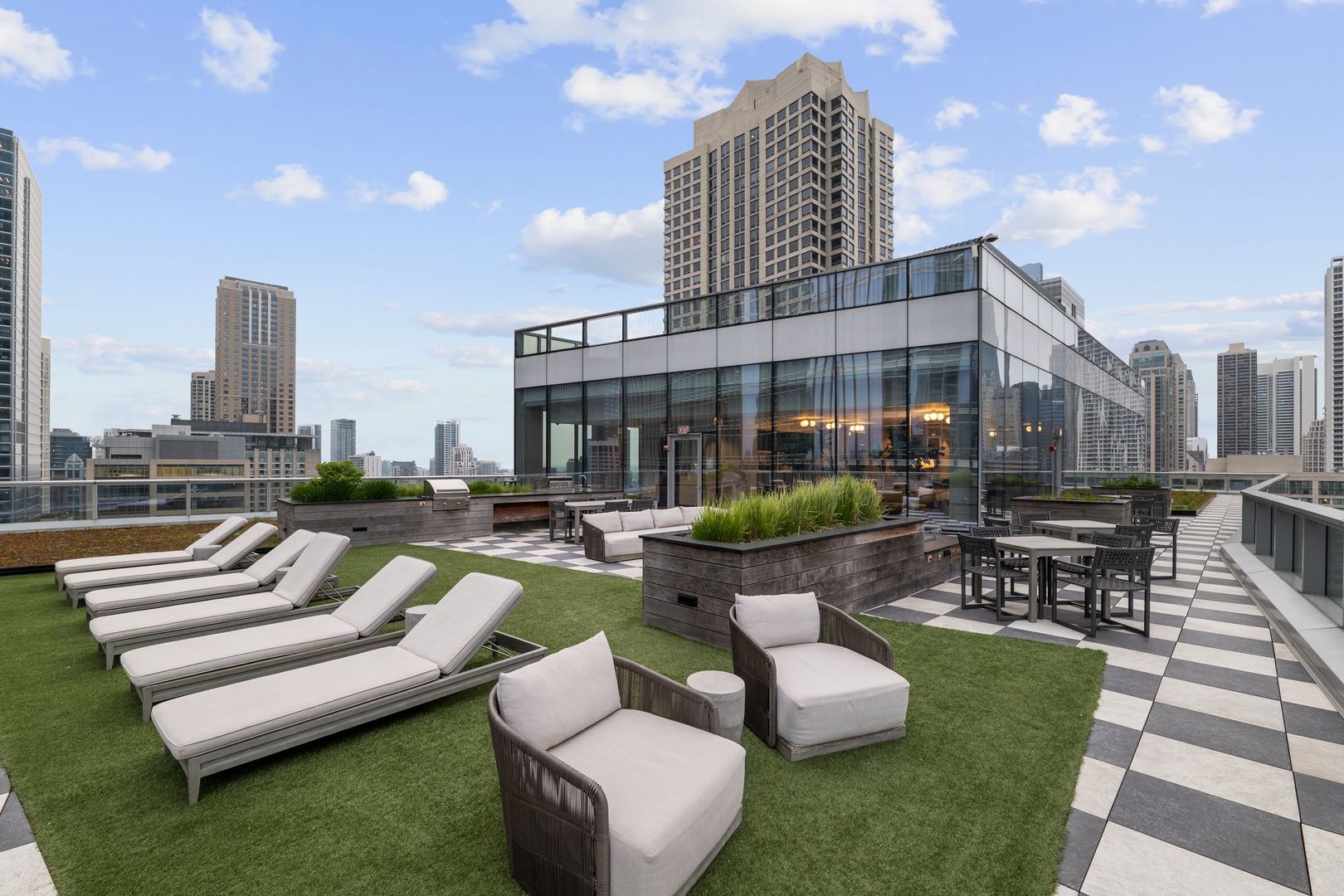 403 North Wabash Avenue, Unit 17C Chicago, IL 60611 - Photo 28 of 30 a view of a patio with couches table and chairs and potted plants