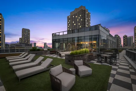 a view of a patio with couches table and chairs and potted plants