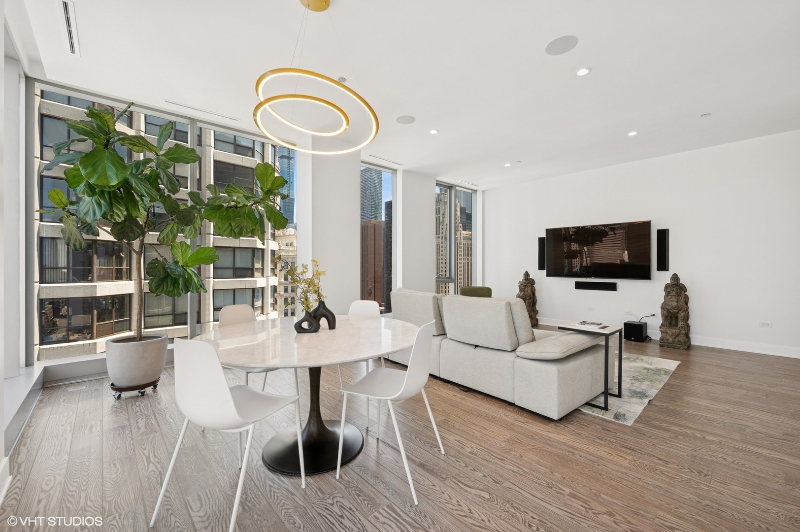 403 North Wabash Avenue, Unit 17C Chicago, IL 60611 - Photo 6 of 30 a living room with furniture a flat screen tv and floor to ceiling window