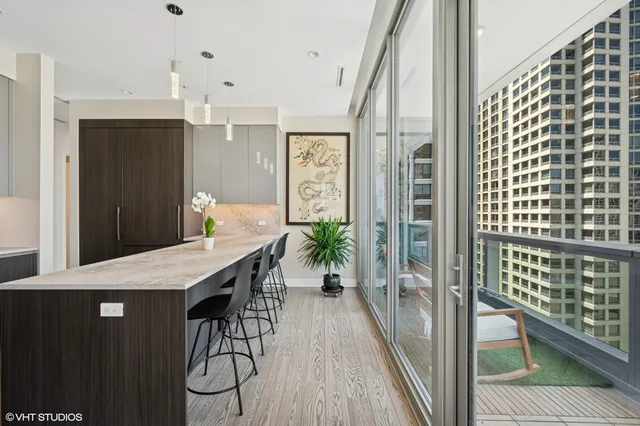 a view of a hallway with furniture and wooden floor
