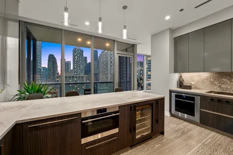 a kitchen with stainless steel appliances granite countertop a stove a sink and a refrigerator