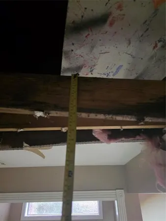 a room with kitchen island a stove a sink dishwasher and a dining table with wooden floor