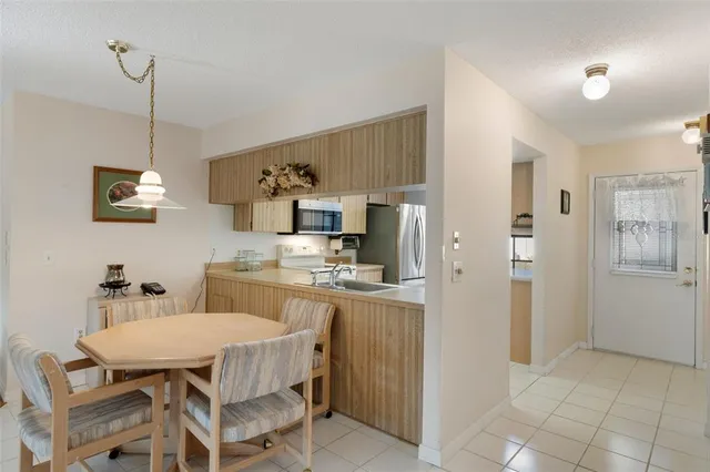 a kitchen with a sink stove and refrigerator