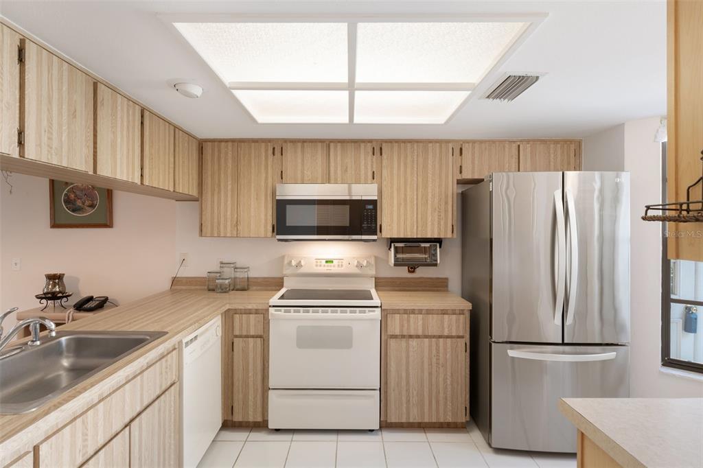6606 Brambleleaf Drive Spring Hill, FL 34606 - Photo 13 of 79 a kitchen with a sink appliances and cabinets