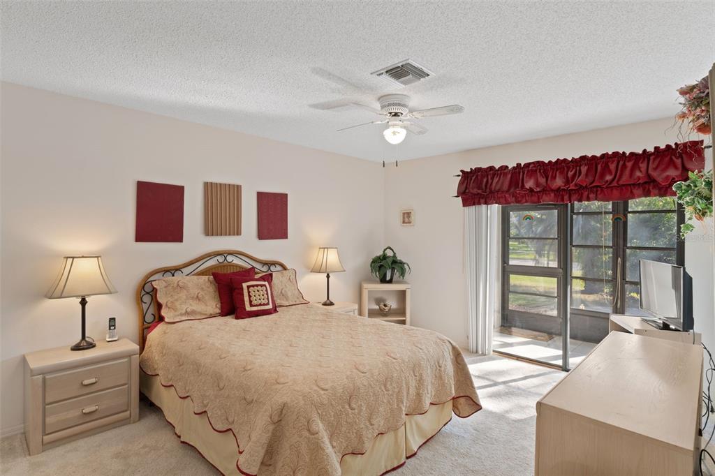 6606 Brambleleaf Drive Spring Hill, FL 34606 - Photo 22 of 79 a bedroom with a large bed and a chandelier