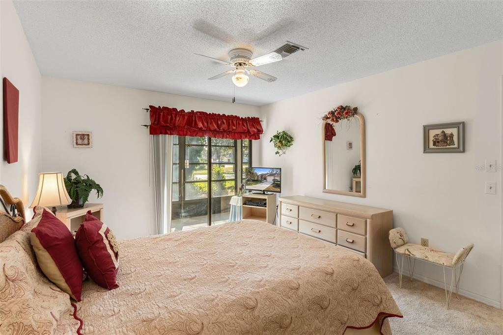 6606 Brambleleaf Drive Spring Hill, FL 34606 - Photo 23 of 79 a bed room with a bed and a chandelier
