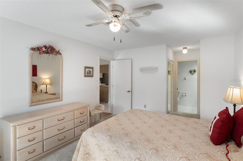 6606 Brambleleaf Drive Spring Hill, FL 34606 - Photo 24 of 79 a spacious bedroom with a bed and a chandelier