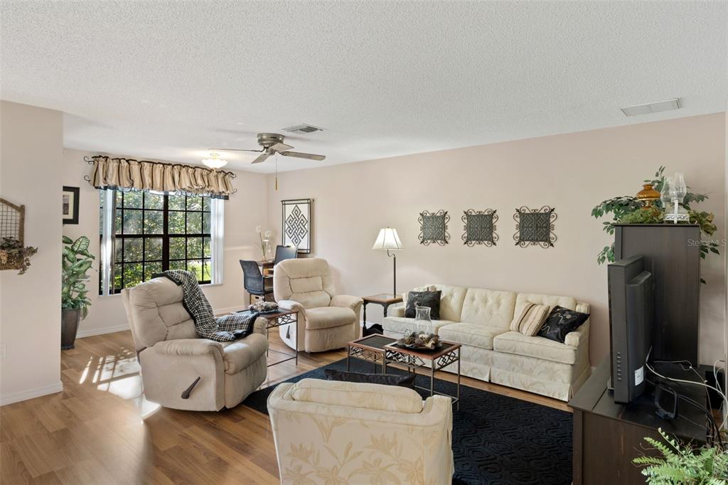 6606 Brambleleaf Drive Spring Hill, FL 34606 - Photo 7 of 79 a living room with furniture and a flat screen tv