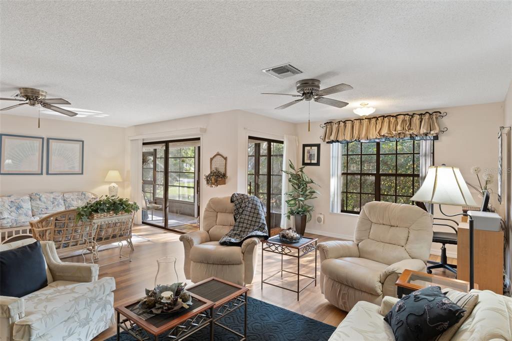 6606 Brambleleaf Drive Spring Hill, FL 34606 - Photo 8 of 79 a living room with furniture ceiling fan and a window