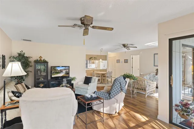 a dining room with furniture and kitchen view