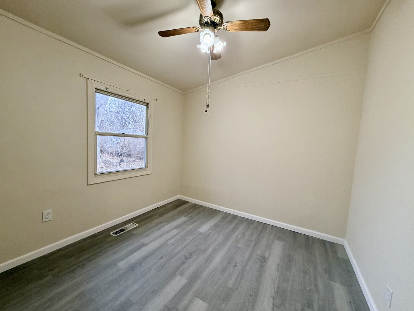 2016 Greendale Drive Champaign, IL 61821 - Photo 12 of 18 an empty room with a window and a fan