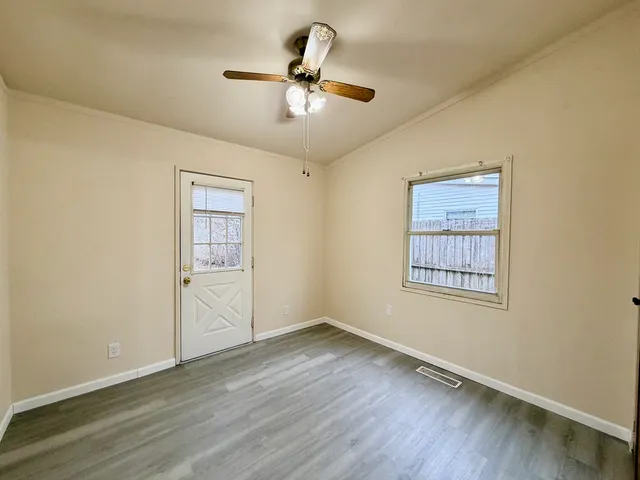 wooden floor in an empty room with a window
