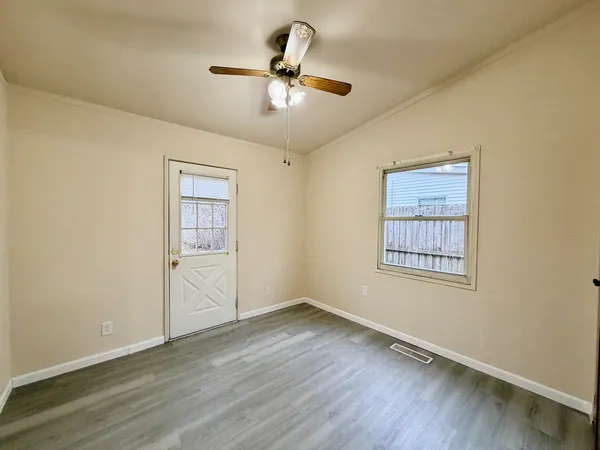 wooden floor in an empty room with a window
