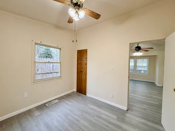 wooden floor in an empty room with a window
