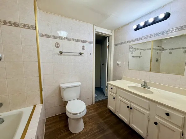 a bathroom with a toilet sink and mirror