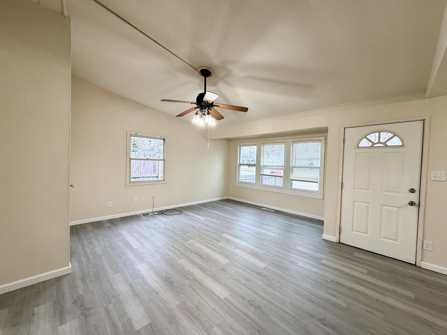 2016 Greendale Drive Champaign, IL 61821 - Photo 3 of 18 an empty room with wooden floor chandelier fan and windows