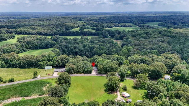 an aerial view of a house with a yard