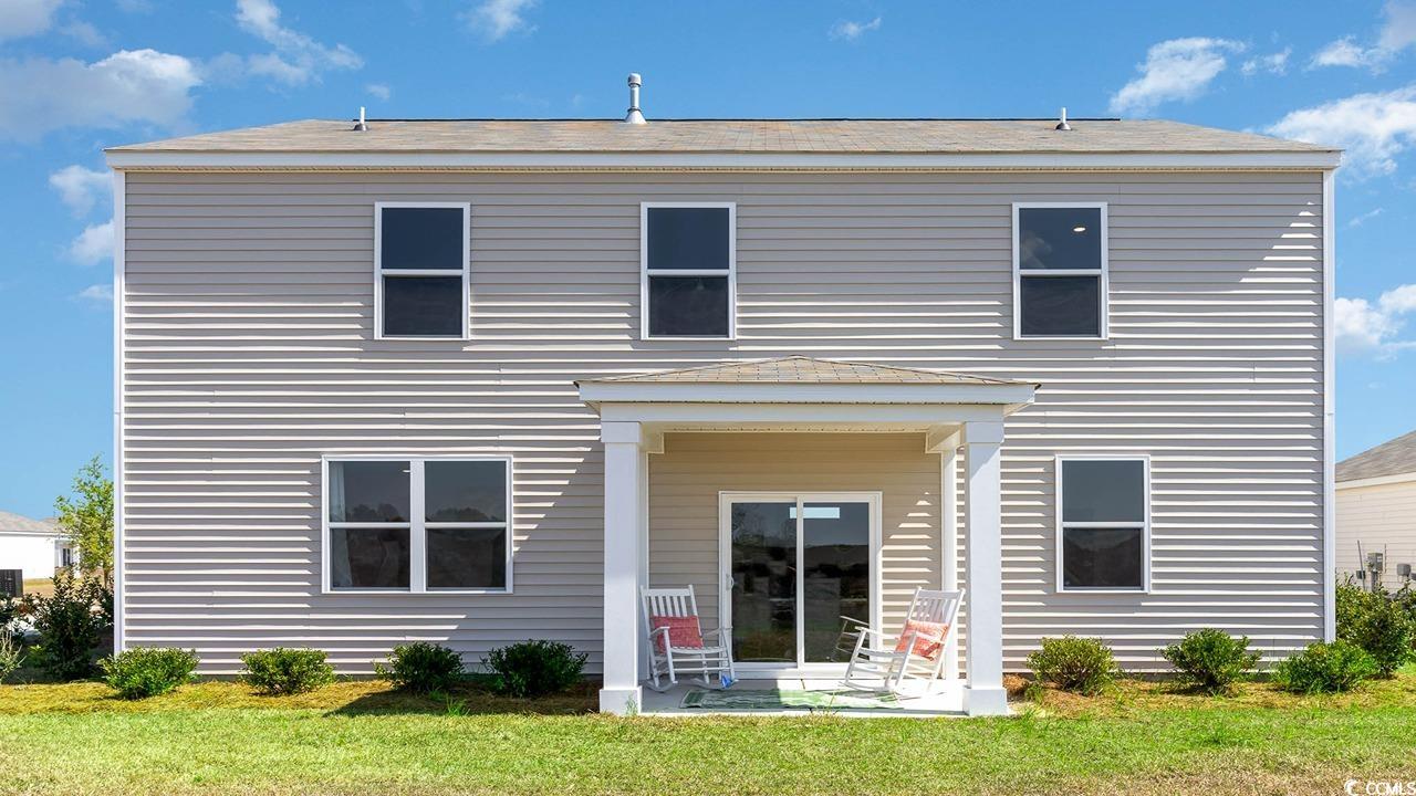 4064 Nelson Road Little River, SC 29566 - Photo 2 of 35 Back of property featuring a lawn