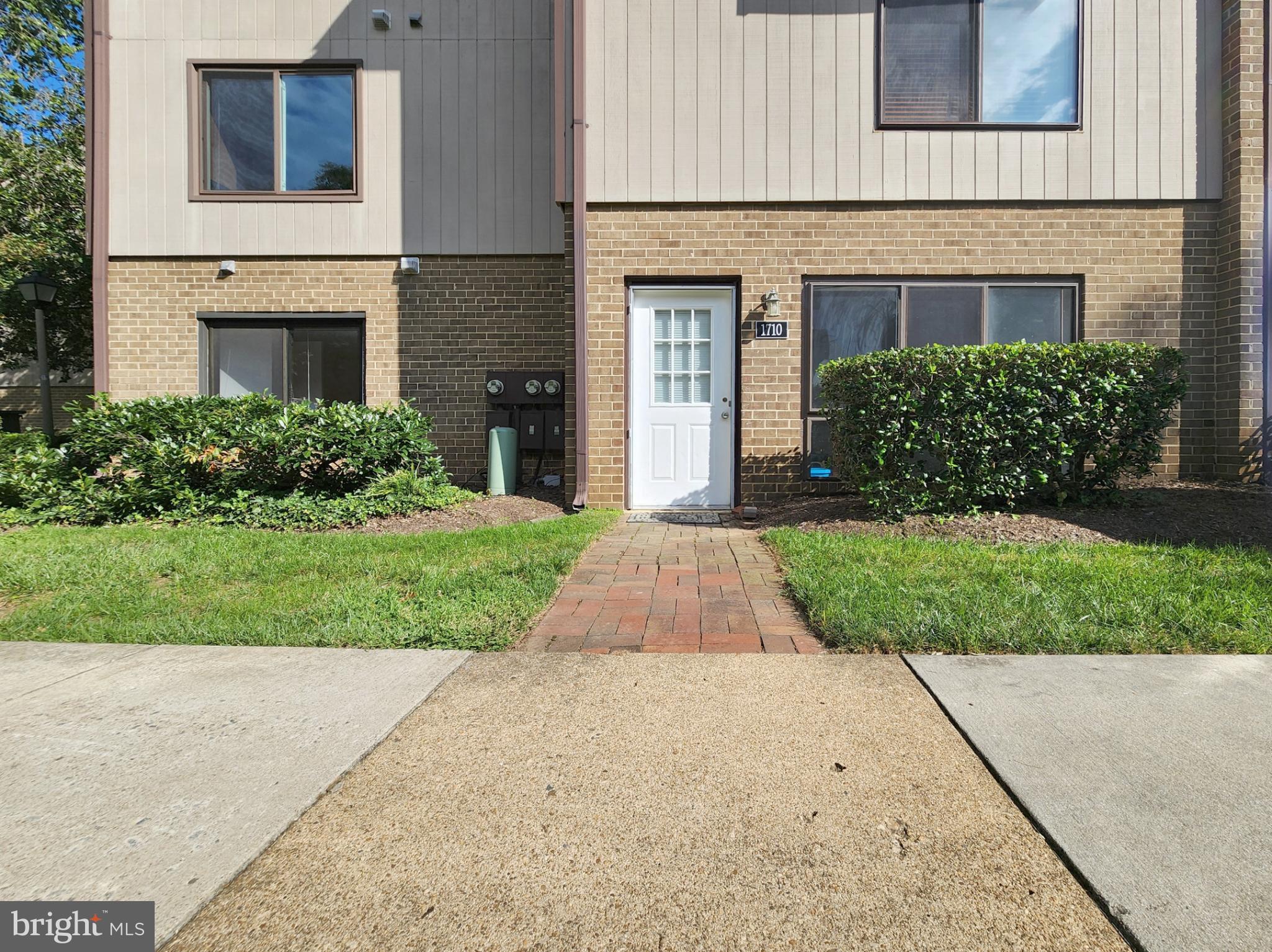 1710 Westwind Way McLean, VA 22102 - Photo 1 of 25 a front view of a house with a yard and garage