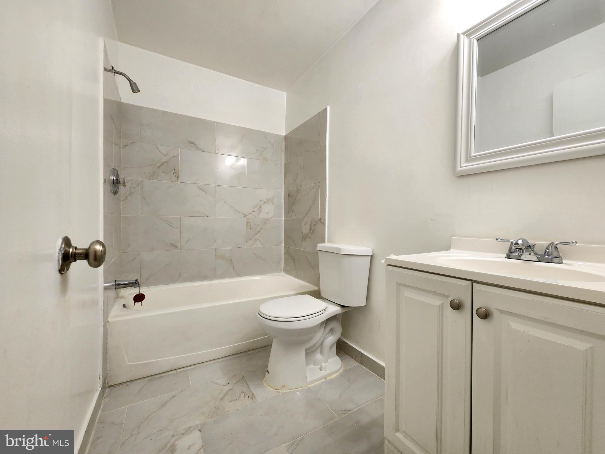 1710 Westwind Way McLean, VA 22102 - Photo 15 of 25 a bathroom with a sink toilet and shower
