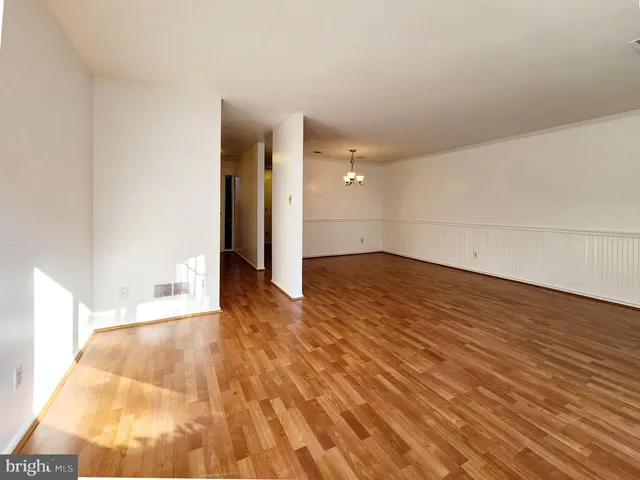 a view of a room with wooden floor