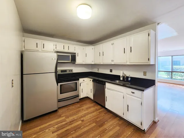 a kitchen with stainless steel appliances a refrigerator and a stove top oven