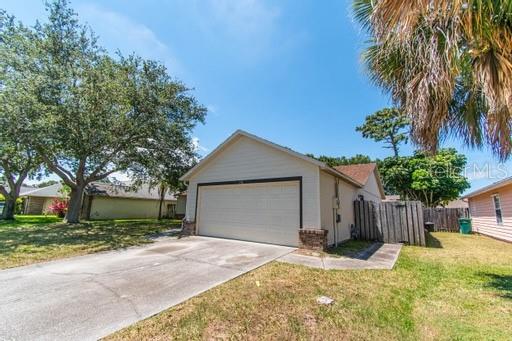 a view of a house with a yard and garage