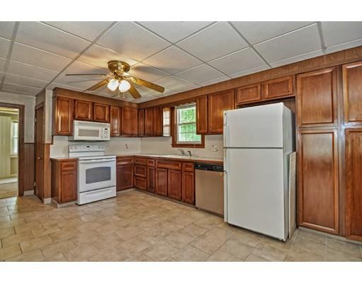 36 Hadwen Road Worcester, MA 01602 - Photo 4 of 19 a kitchen with stainless steel appliances granite countertop a refrigerator a oven a sink with a dining table and chairs