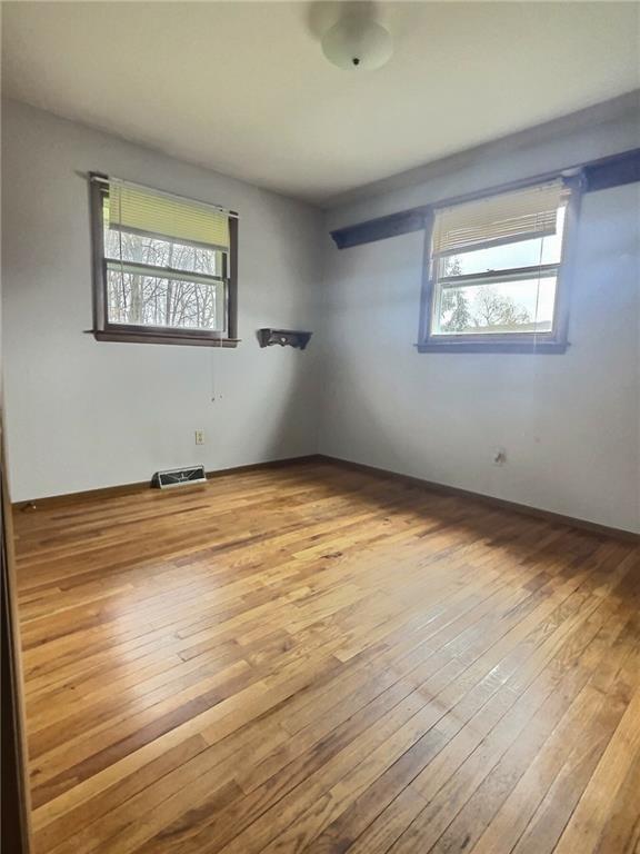 7749 Lamor Road Mercer, PA 16137 - Photo 11 of 17 a view of an empty room with wooden floor and a window