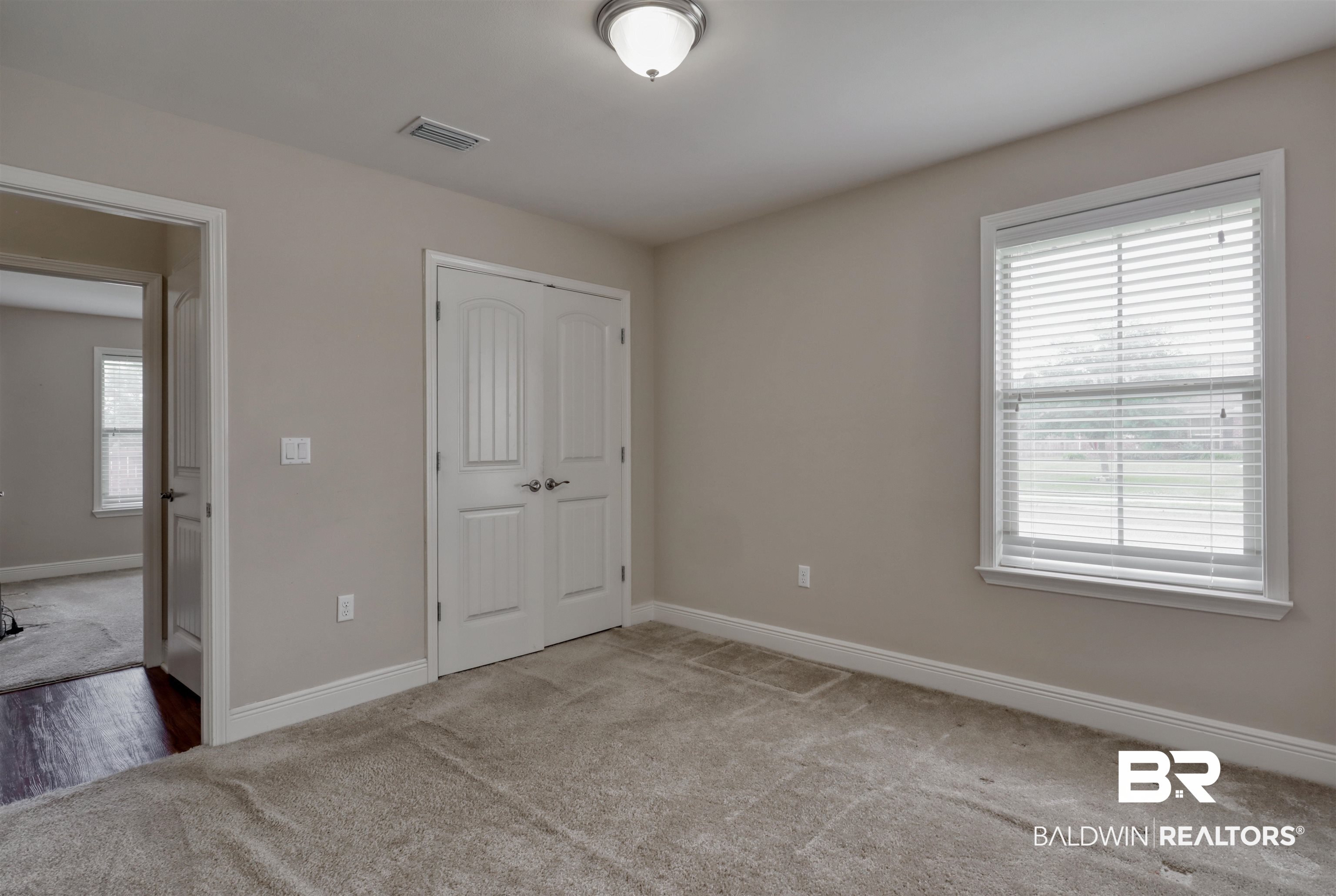 14794 Troon Drive Foley, AL 36535 - Photo 19 of 33 Unfurnished bedroom with carpet floors, baseboards, a closet, and visible vents