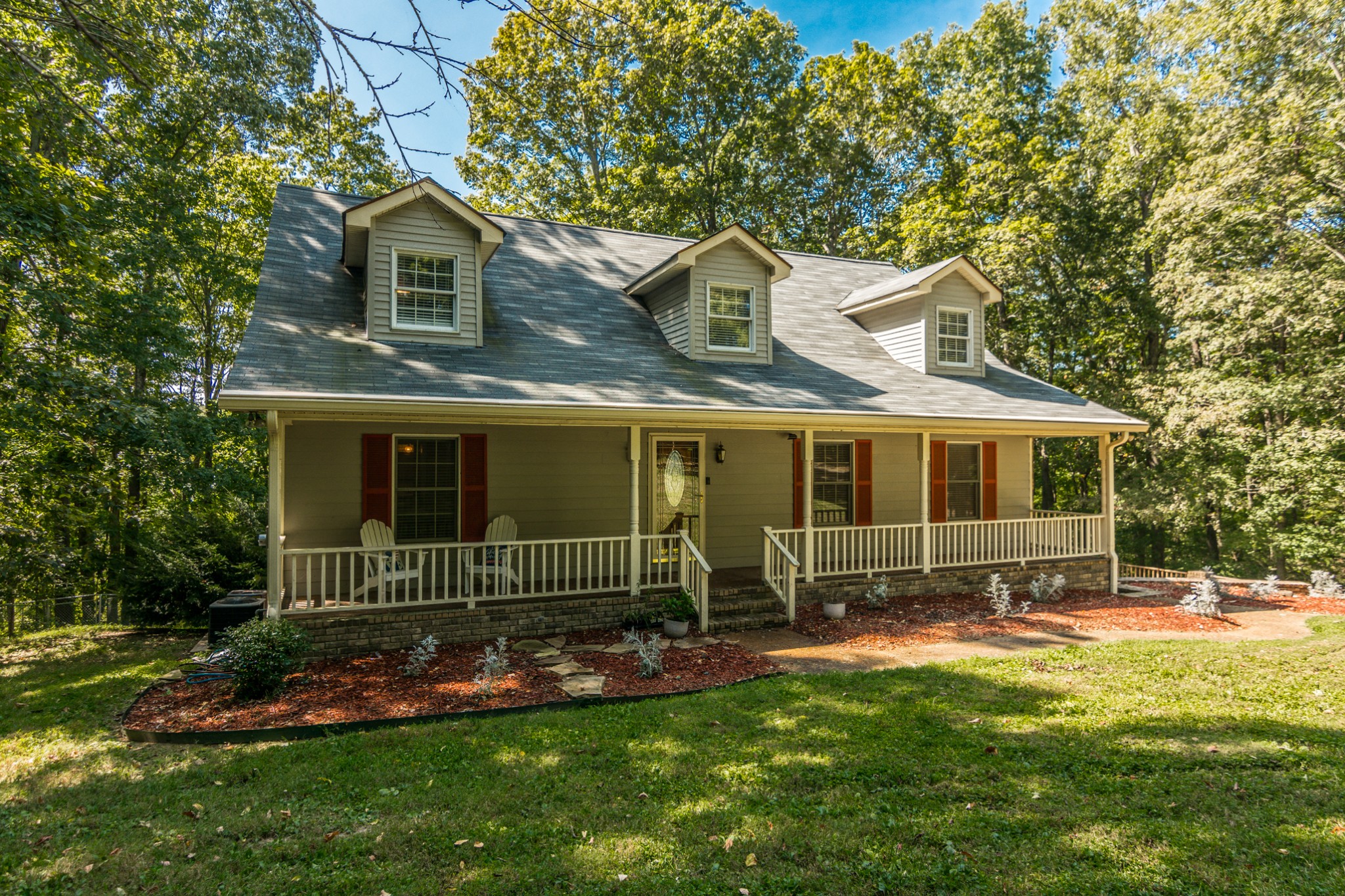 a front view of a house with a garden