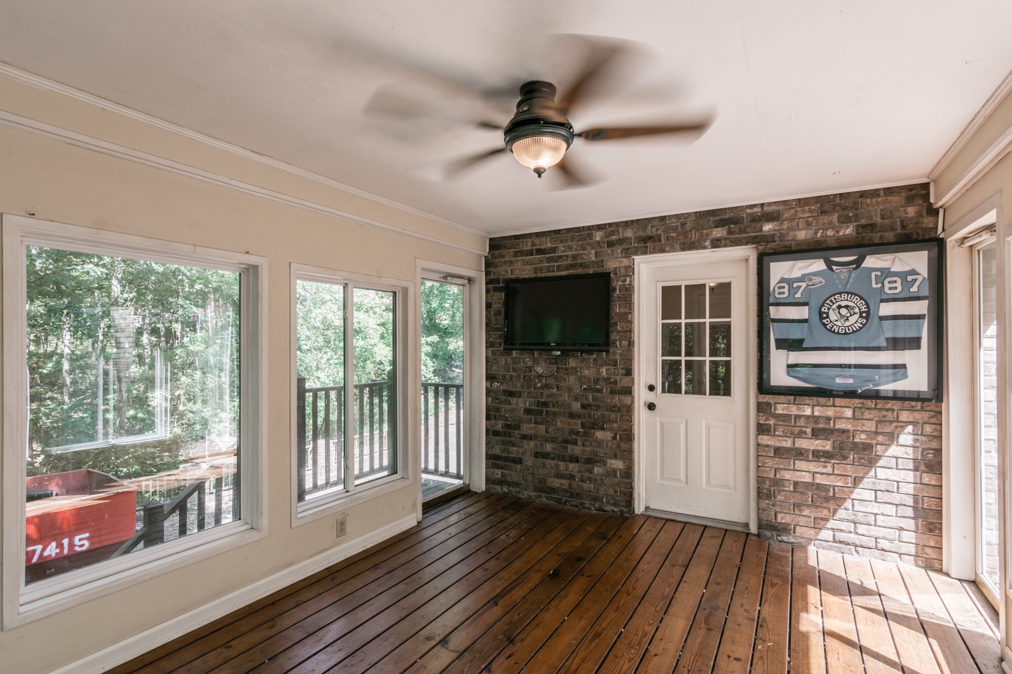 5207 Stacy Springs Road Springfield, TN 37172 - Photo 21 of 30 a view of a livingroom with wooden floor and a ceiling fan