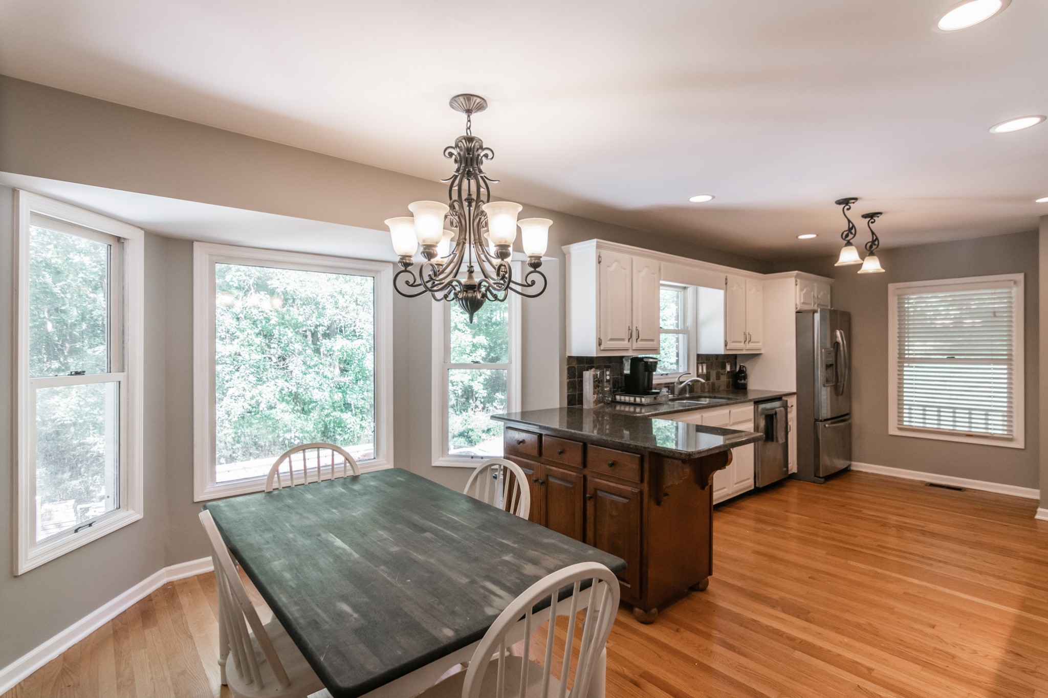 5207 Stacy Springs Road Springfield, TN 37172 - Photo 8 of 30 a kitchen with kitchen island granite countertop a stove and a wooden floor