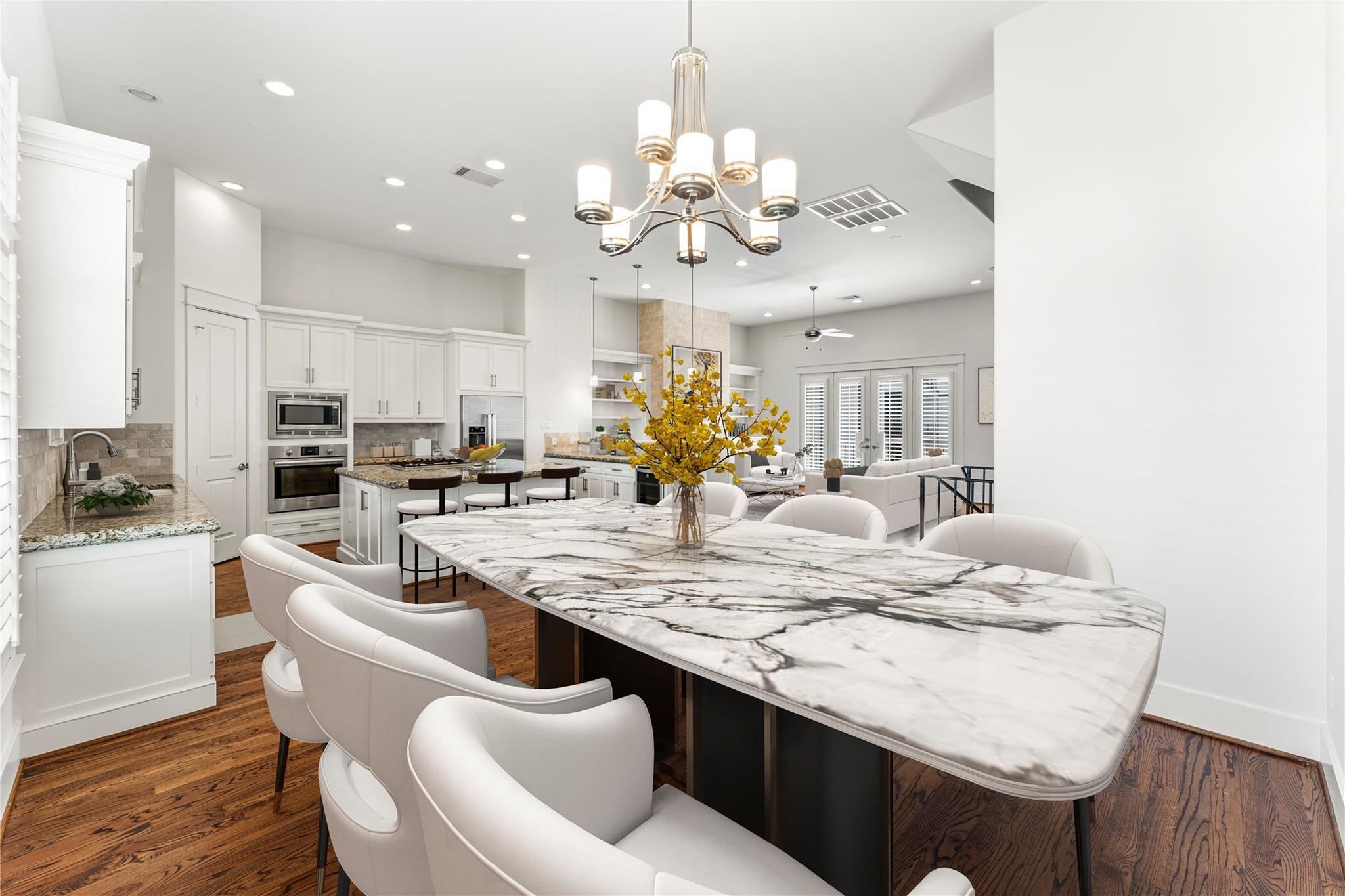 4938 Edison Park Lane Houston, TX 77081 - Photo 12 of 49 Natural light pours in through
large windows accented by
plantation shutters, seamlessly
connecting the living, dining, and
kitchen spaces. Designed for
both everyday living and
entertaining, this level embodies
effortless luxury and flow.
*virtually staged