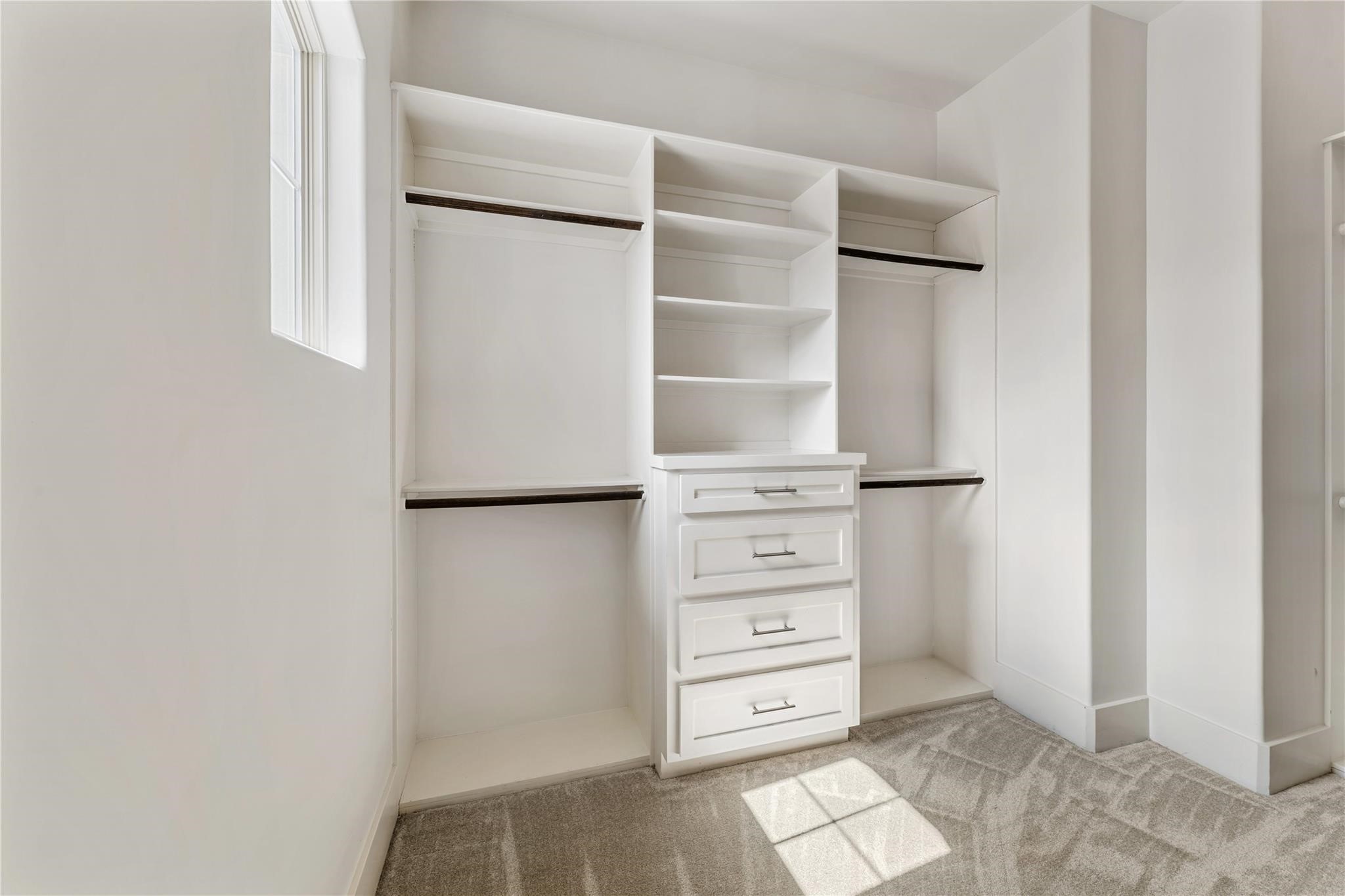 4938 Edison Park Lane Houston, TX 77081 - Photo 36 of 49 a view of walk in closet with empty racks