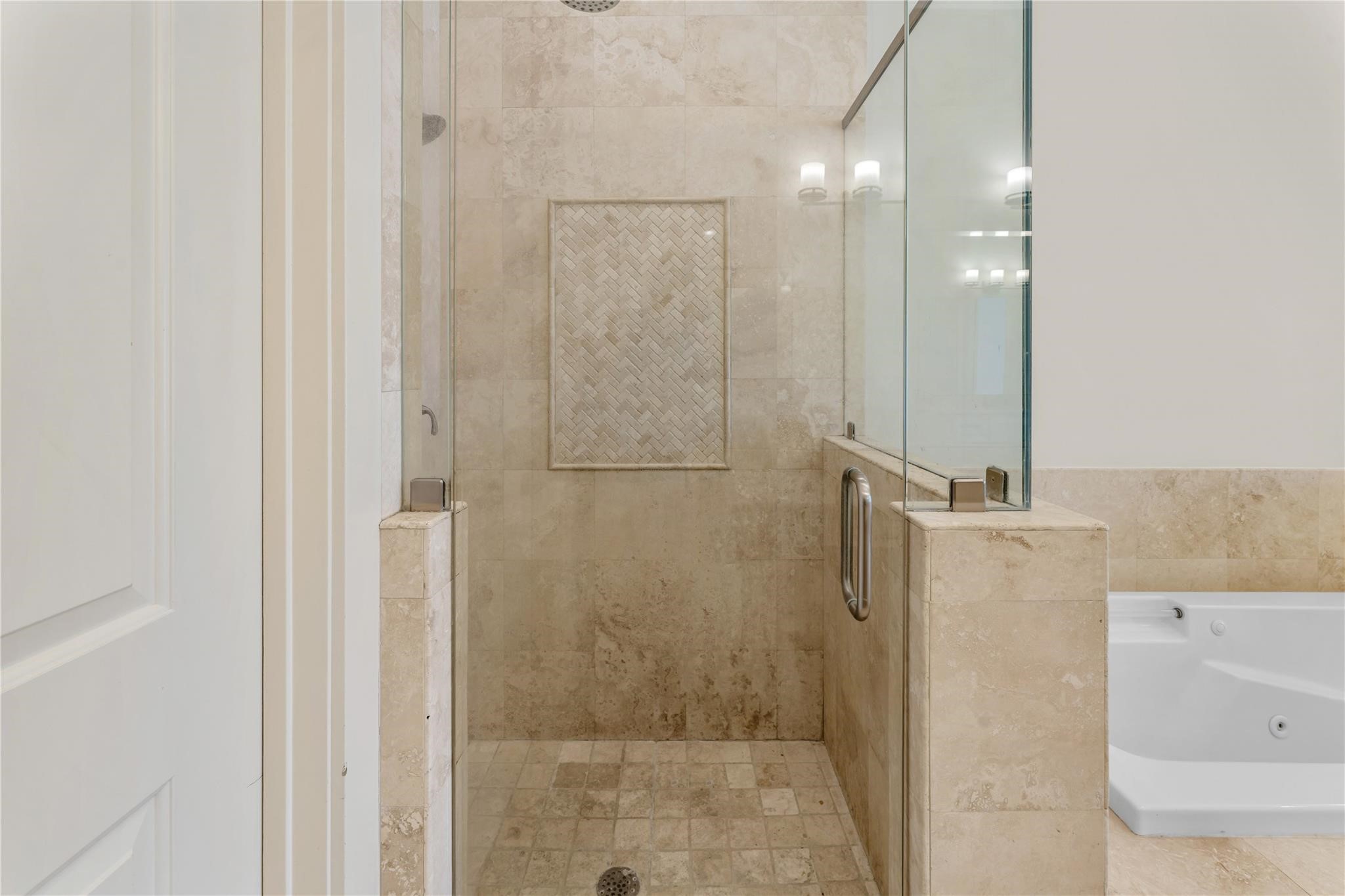 4938 Edison Park Lane Houston, TX 77081 - Photo 40 of 49 Primary bath offers a spa-like
retreat with a jetted soaking tub,
separate glass shower with dual
sprayer heads, and elegant
finishes throughout.