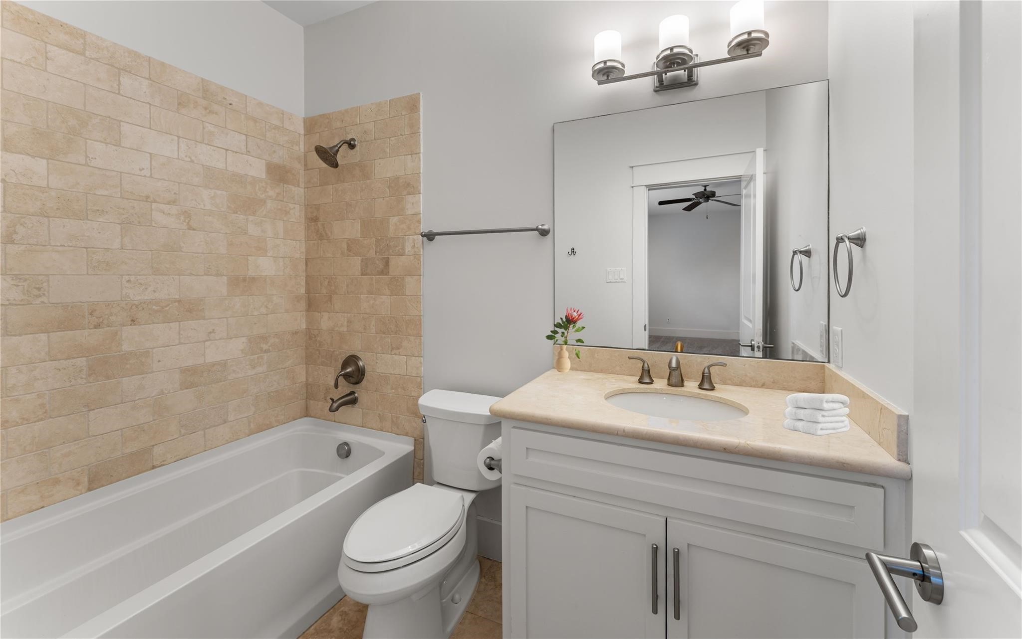 4938 Edison Park Lane Houston, TX 77081 - Photo 10 of 49 a bathroom with a sink a toilet and a bathtub