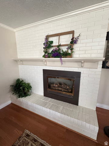 254 Meadow Lane Centerville, UT 84014 - Photo 7 of 34 White-painted brick fireplace with a dark-framed insert, a substantial mantel shelf, and a raised hearth