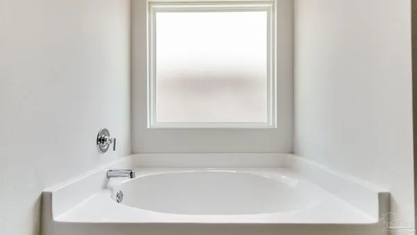 a white bath tub sitting next to a window
