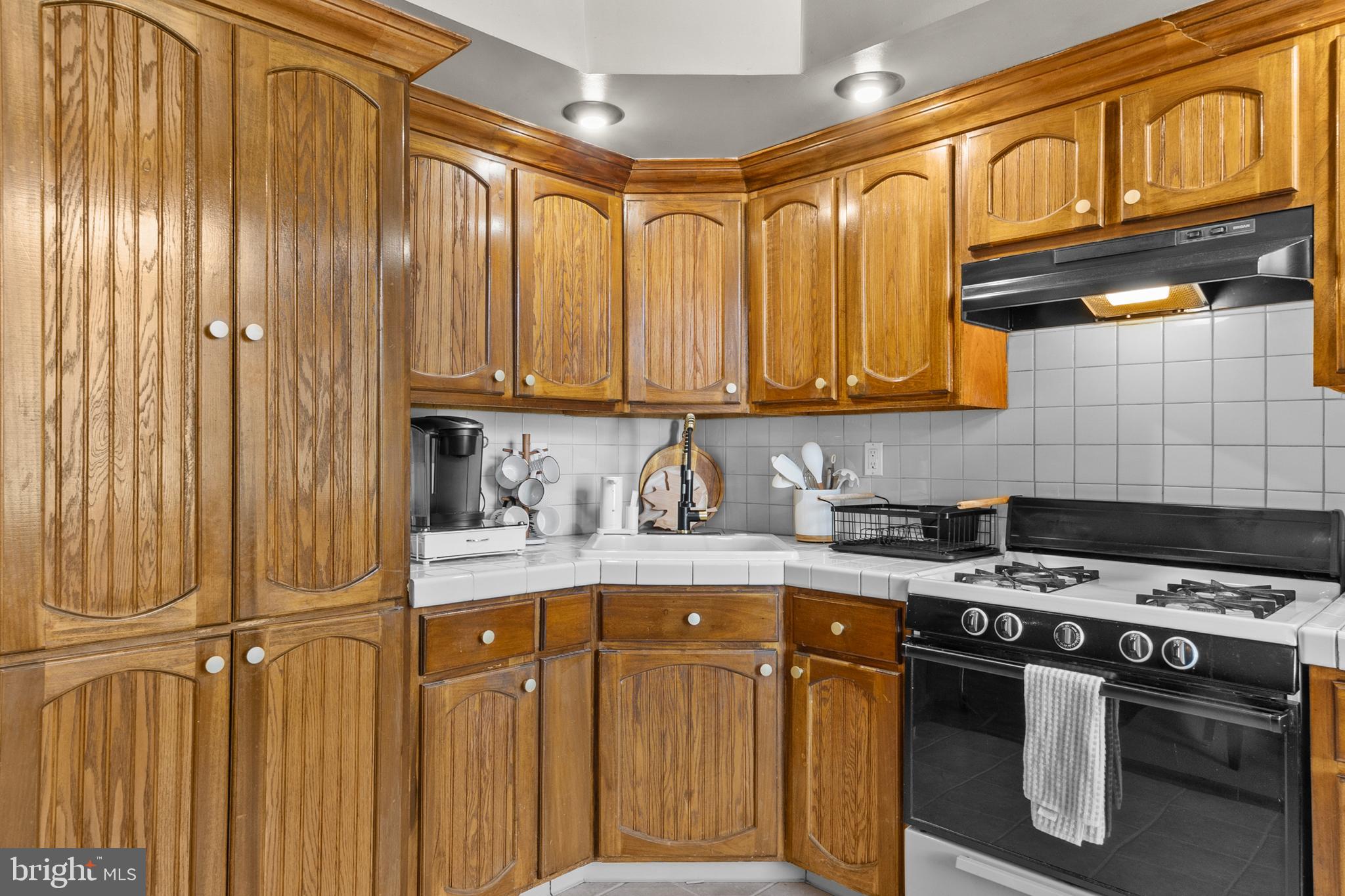 1642-44 Ridge Avenue Philadelphia, PA 19130 - Photo 11 of 24 a kitchen with stainless steel appliances granite countertop a stove a sink and dishwasher