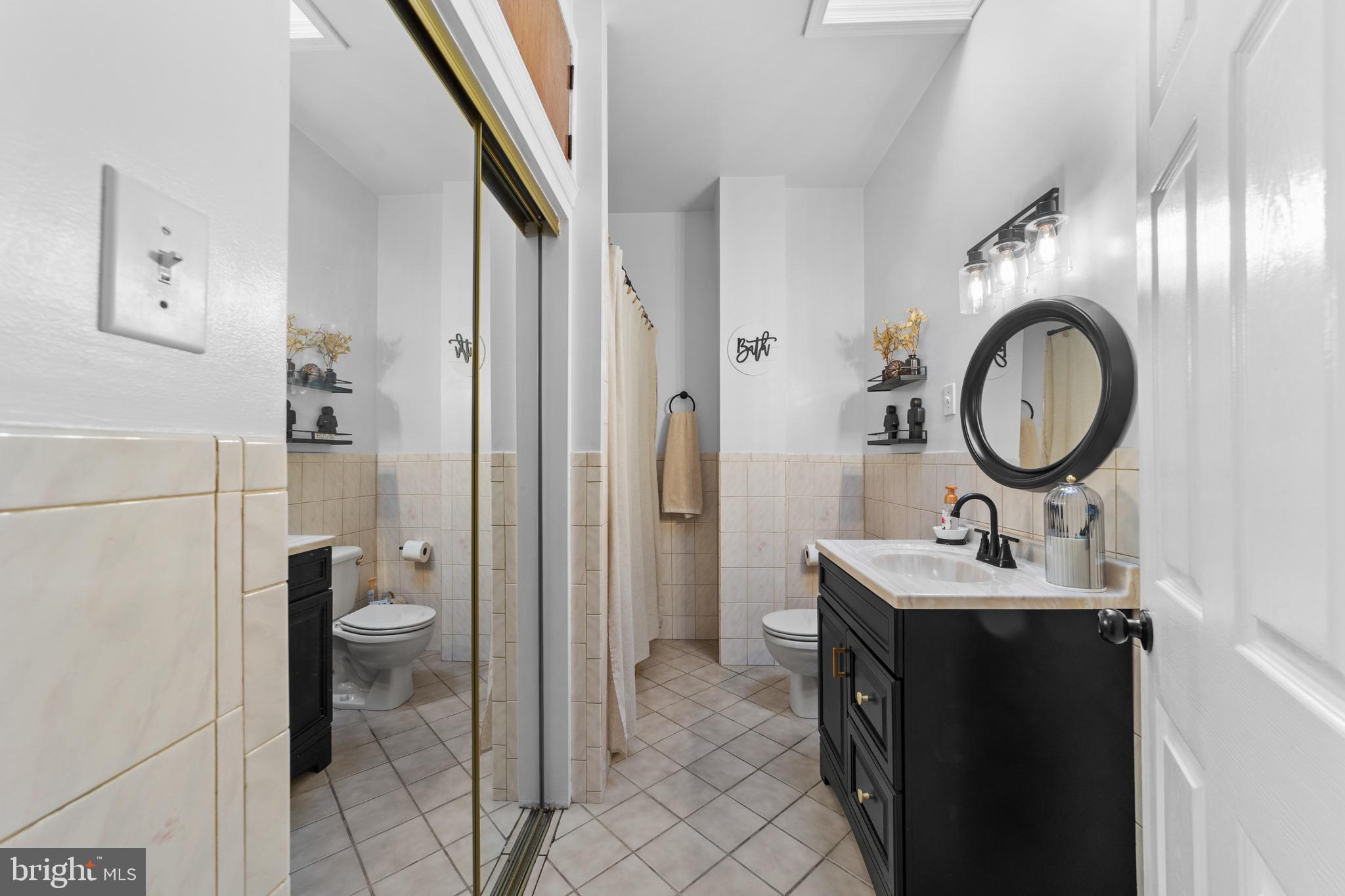 1642-44 Ridge Avenue Philadelphia, PA 19130 - Photo 16 of 24 a bathroom with a sink and a mirror